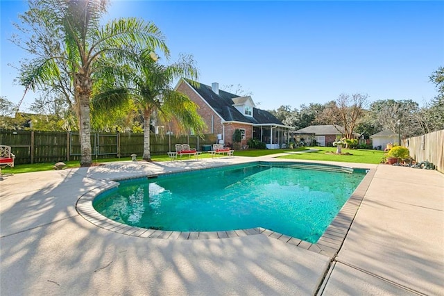 view of swimming pool with a lawn and a patio