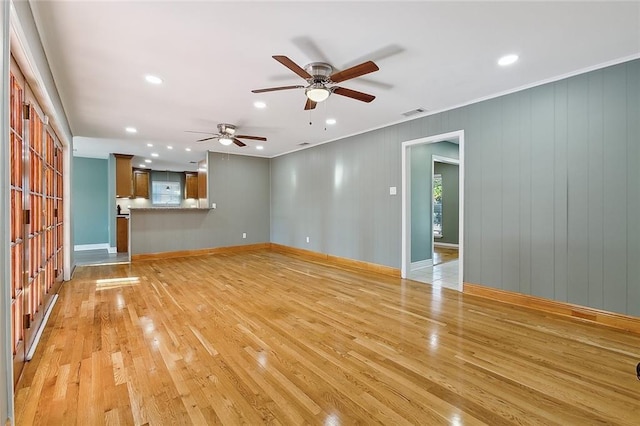 unfurnished living room featuring light hardwood / wood-style flooring and ceiling fan