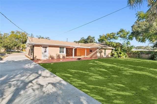 rear view of property with a patio area and a yard