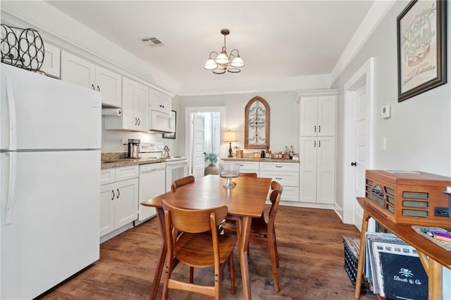 dining area featuring dark wood-type flooring and a notable chandelier