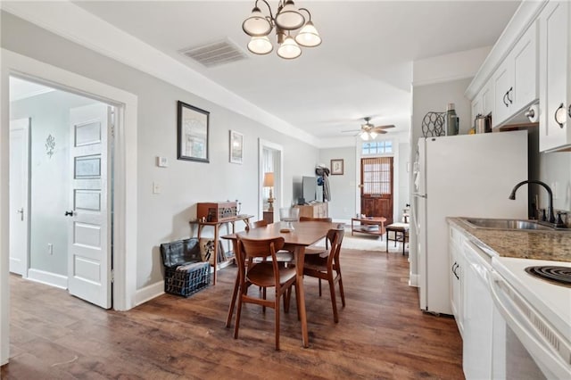 dining room with dark hardwood / wood-style flooring, sink, and ceiling fan with notable chandelier