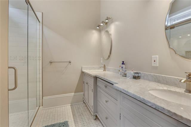 bathroom with vanity and a shower with shower door