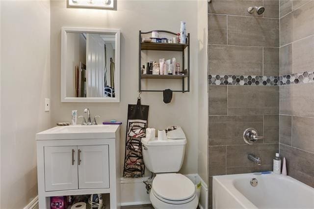 full bathroom with vanity, toilet, and tiled shower / bath combo