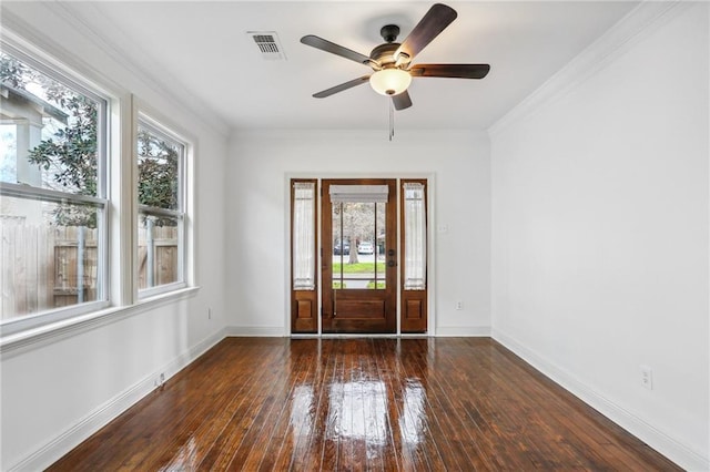 foyer with ceiling fan, a healthy amount of sunlight, dark hardwood / wood-style flooring, and ornamental molding