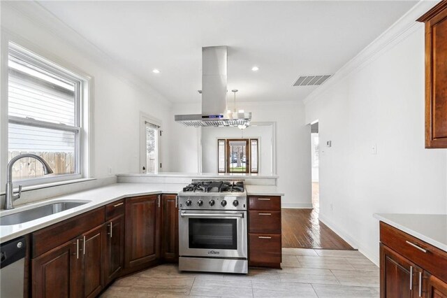 kitchen featuring island exhaust hood, stainless steel range, dishwashing machine, crown molding, and sink