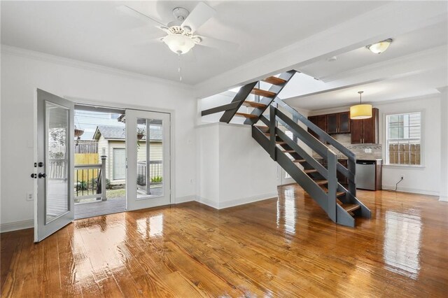 unfurnished room featuring ceiling fan, dark hardwood / wood-style floors, ornamental molding, and french doors