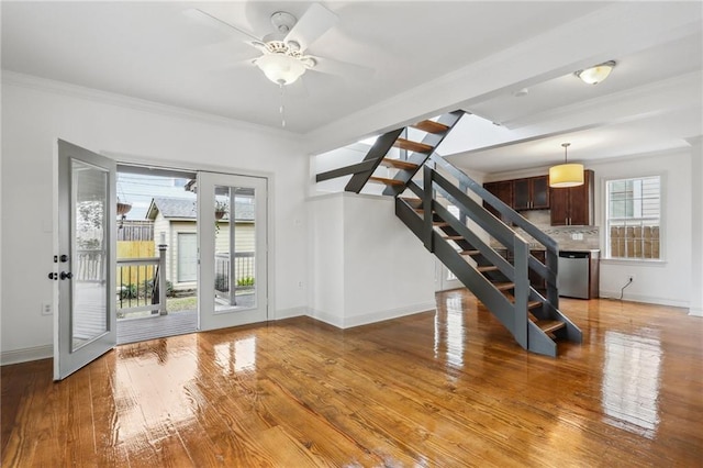 interior space featuring ceiling fan, light hardwood / wood-style flooring, and ornamental molding