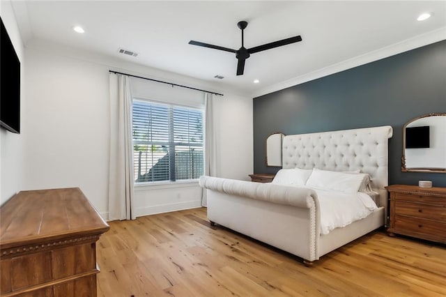 bedroom with light hardwood / wood-style floors, ceiling fan, and ornamental molding