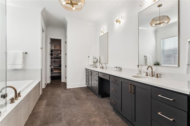 bathroom featuring a bath, vanity, and ornamental molding