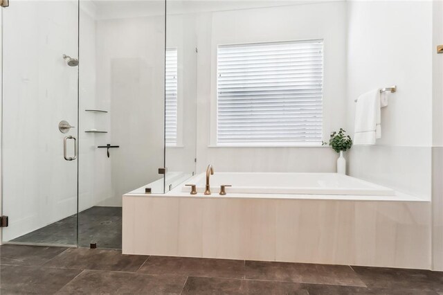 bathroom featuring separate shower and tub