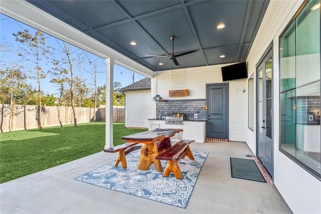 view of patio featuring an outdoor kitchen, ceiling fan, and grilling area