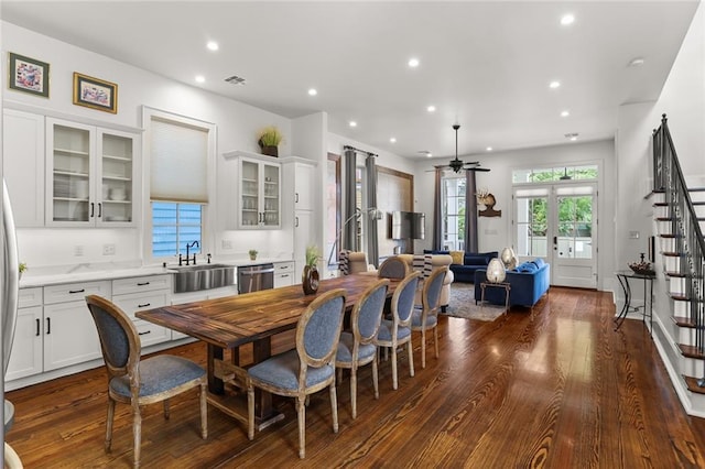 dining area featuring dark hardwood / wood-style flooring, ceiling fan, sink, and french doors