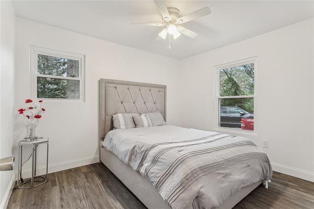 bedroom featuring ceiling fan and dark wood-type flooring