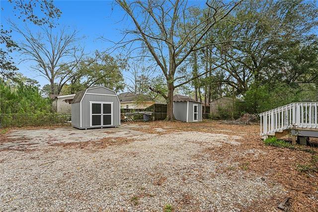 view of yard featuring a storage unit and a deck