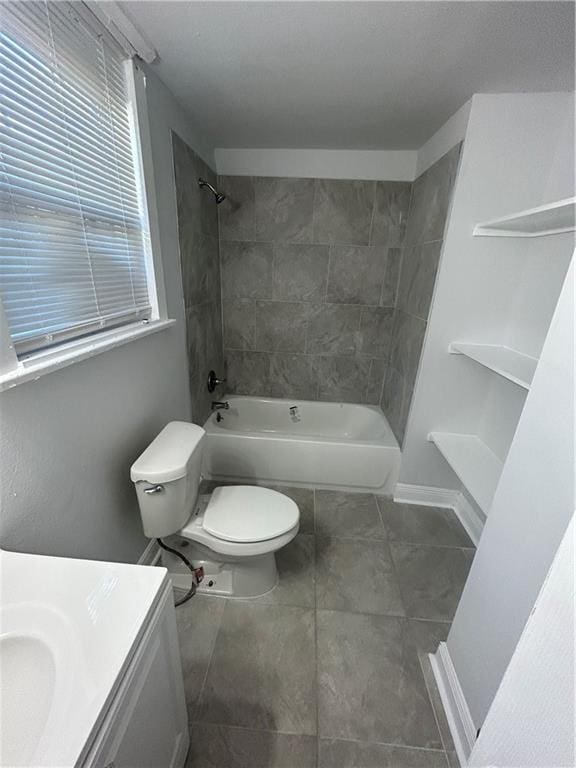 full bathroom with tiled shower / bath combo, toilet, and vanity