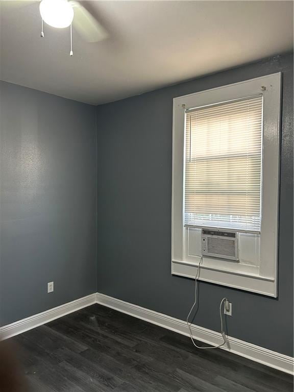 unfurnished room featuring ceiling fan, cooling unit, and dark hardwood / wood-style flooring