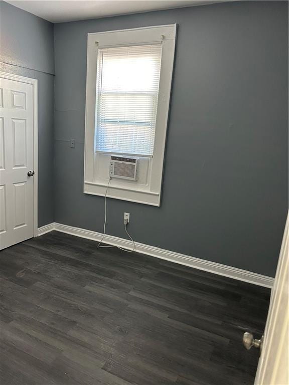 spare room featuring dark hardwood / wood-style floors and cooling unit