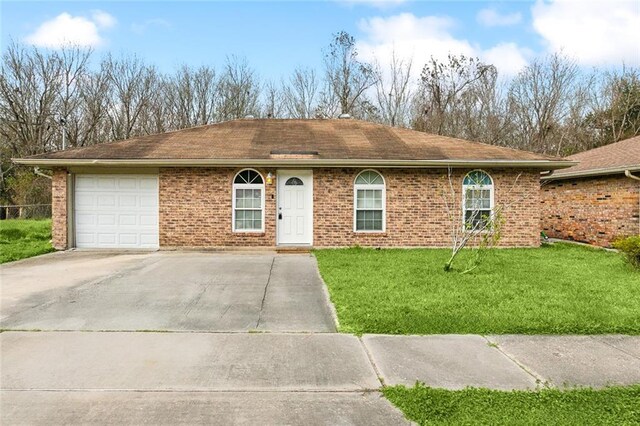 single story home featuring a front yard and a garage