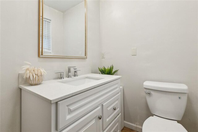 bathroom with toilet and vanity