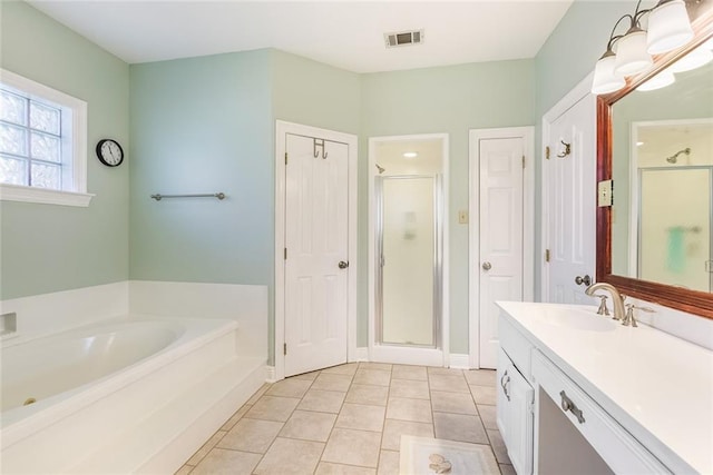 bathroom with tile patterned flooring, shower with separate bathtub, and vanity