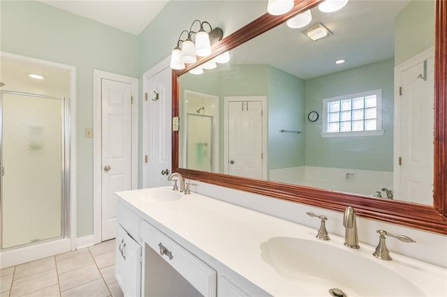 bathroom featuring tile patterned floors, vanity, and walk in shower