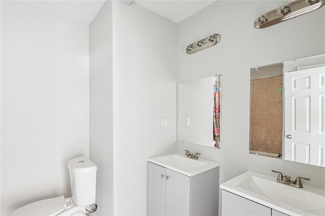 bathroom featuring toilet and vanity