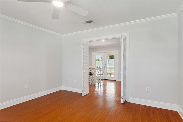 2525 Paul St, Meraux, LA 70075 - spare room with ceiling fan, hardwood / wood-style floors, crown molding, and french doors