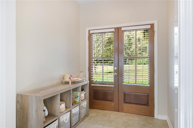 doorway with french doors and light tile patterned floors