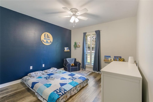 bedroom with light hardwood / wood-style flooring and ceiling fan