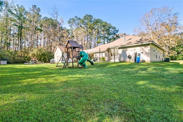 view of yard featuring a playground and central AC unit