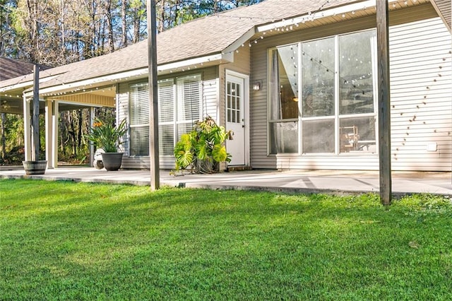 rear view of house featuring a patio area and a yard