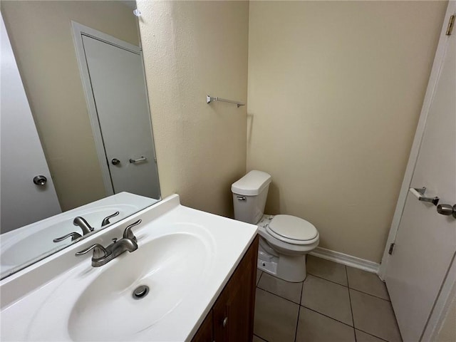 bathroom featuring tile patterned floors, vanity, and toilet