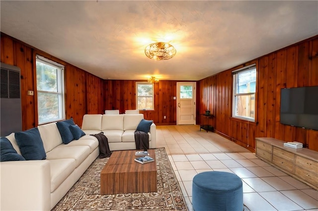 living room featuring wooden walls and light tile patterned flooring