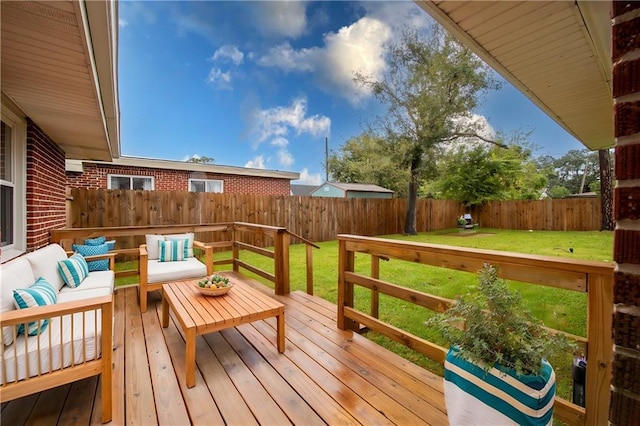 deck with an outdoor living space and a yard