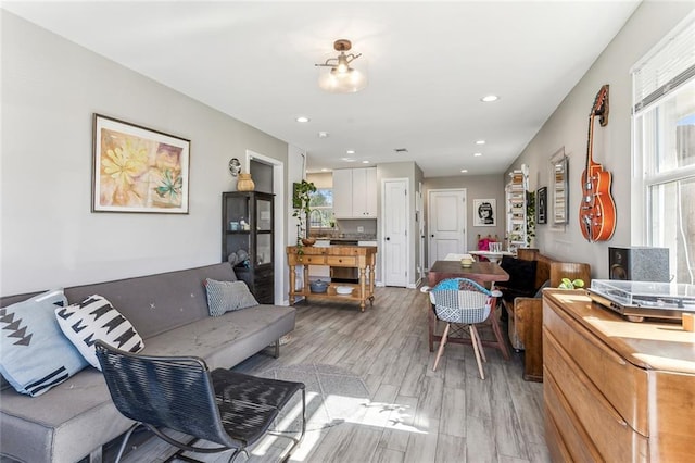 living room with sink and light wood-type flooring