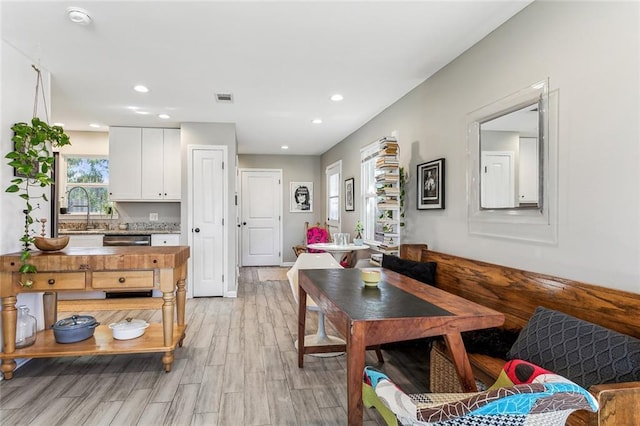 dining room featuring light hardwood / wood-style floors and sink