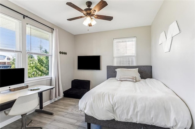 bedroom with light hardwood / wood-style flooring and ceiling fan