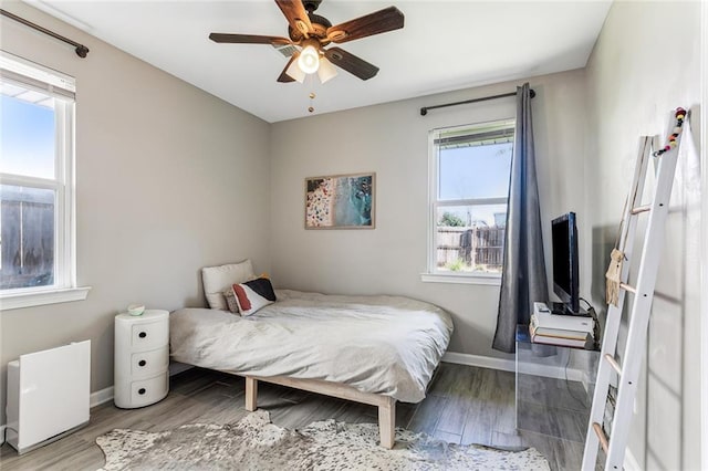 bedroom with hardwood / wood-style floors and ceiling fan