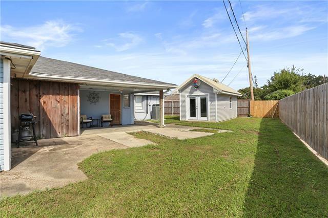 view of yard featuring a fenced backyard, an outdoor structure, french doors, and a patio