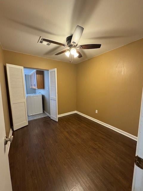 unfurnished bedroom with ceiling fan and dark wood-type flooring