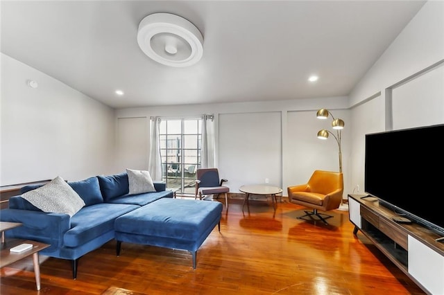 living room with hardwood / wood-style floors and lofted ceiling