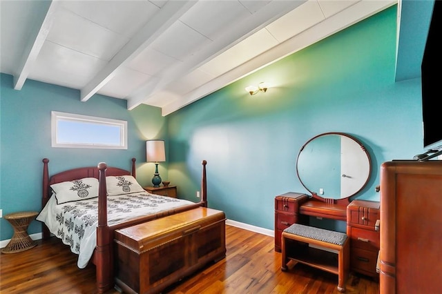 bedroom featuring beam ceiling and dark hardwood / wood-style flooring