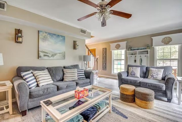 living room featuring ceiling fan and crown molding