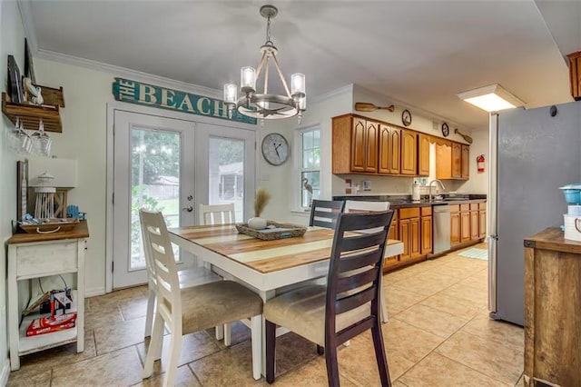 dining space with sink, french doors, a notable chandelier, light tile patterned floors, and ornamental molding