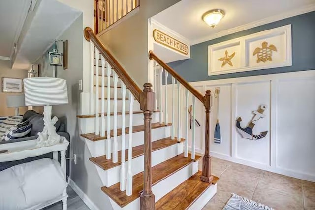 stairway featuring ornamental molding