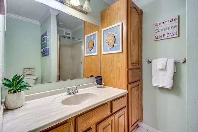 bathroom featuring tile patterned floors, walk in shower, ornamental molding, vanity, and toilet