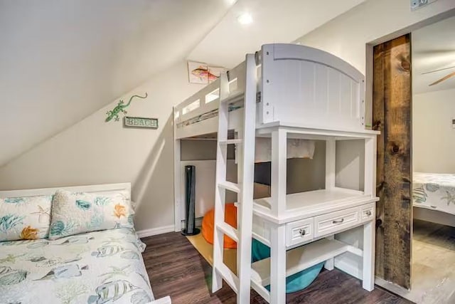 bedroom featuring dark hardwood / wood-style flooring and lofted ceiling