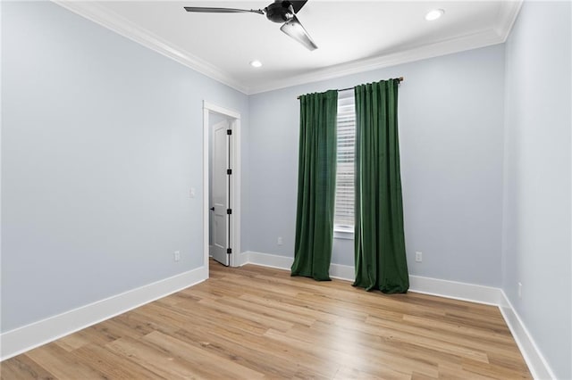 empty room featuring crown molding, light hardwood / wood-style flooring, and ceiling fan