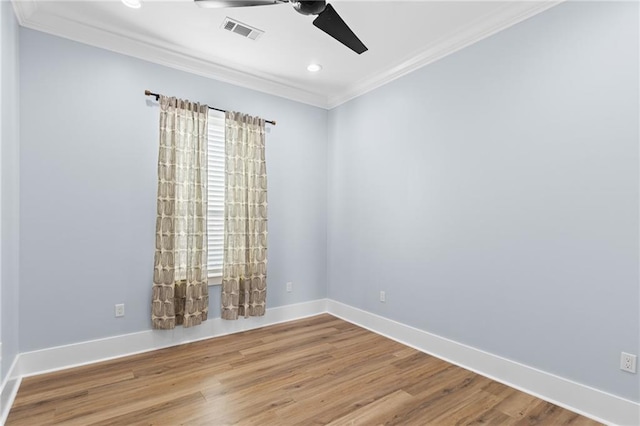 empty room with ceiling fan, ornamental molding, and hardwood / wood-style flooring