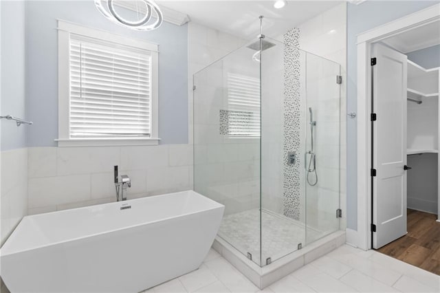 bathroom featuring tile patterned floors, plenty of natural light, and shower with separate bathtub